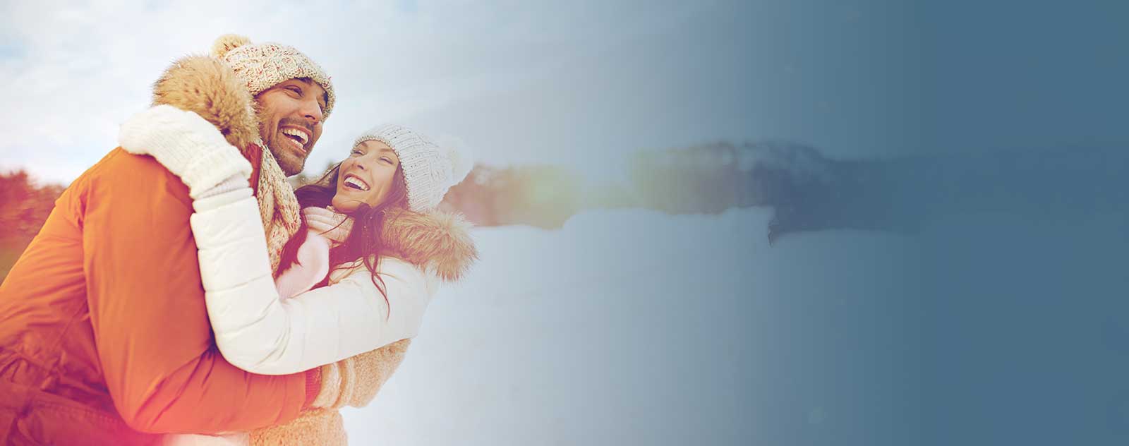 young couple smiling in the snow